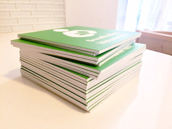 Stack of green 'Breastfeeding Welcome Here' signs