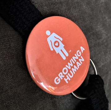 Growing a Human Graphic Pin - English
